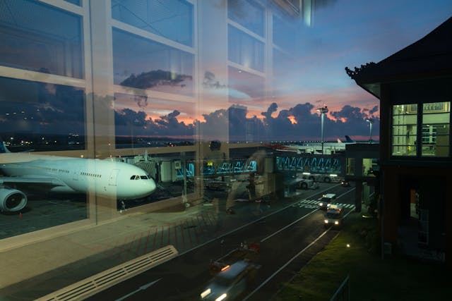 an airplane at its gates during sunset