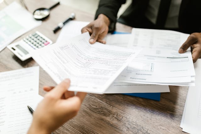 two people looking over tax forms