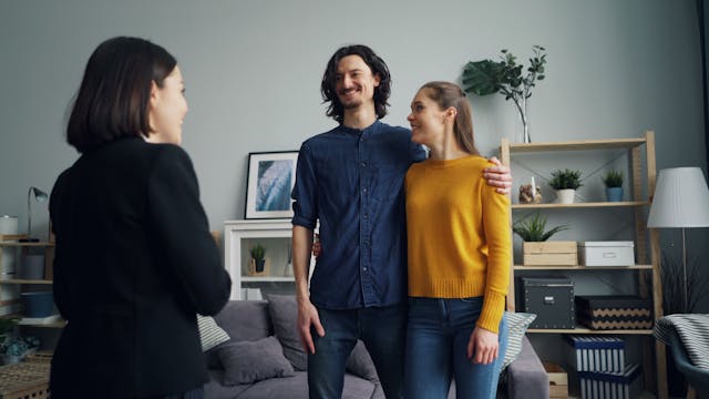 two prospective tenants speaking with a landlord