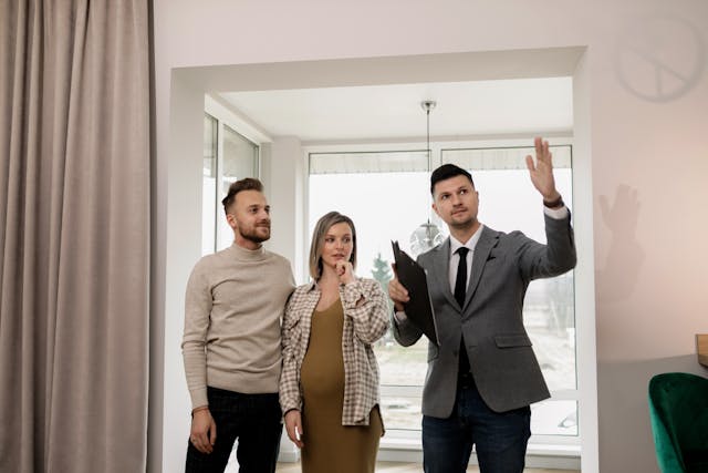 person conducting a property tour to two prospective tenants