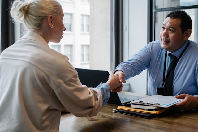 a landlord and tenant shaking hands after signing a contract