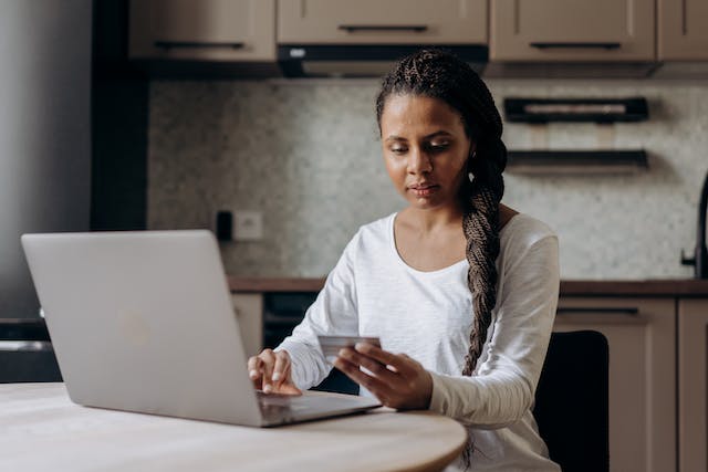 tenant paying their rent online with a credit card and laptop