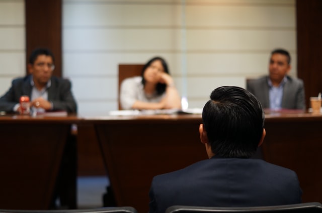 a person sitting through an eviction hearing in court