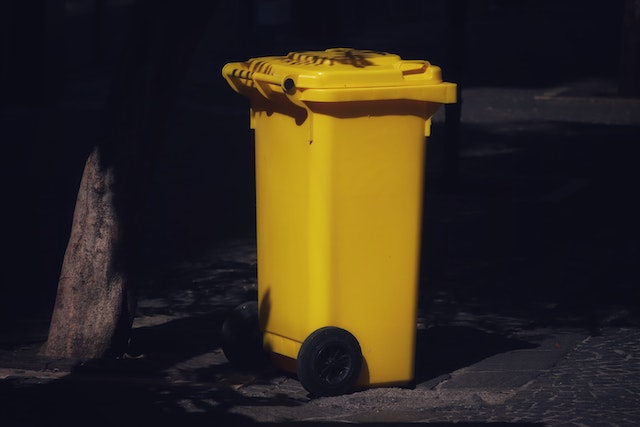 large yellow garbage can on wheels