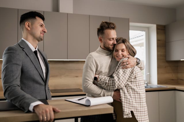 two people hugging after signing a rental agreement